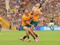 Noah Lolesio (10 Australia) and Tom Wright (15 Australia) collide while attempting to catch the ball during the match between the Wallabies and Springboks on August 8, 2024