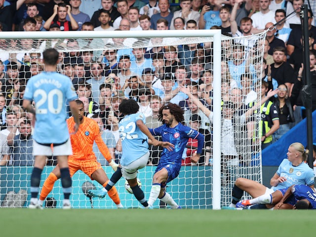 Manchester City's Rico Lewis scores a goal before it is disallowed for a foul by Manchester City's Erling Haaland during the Premier League match on August 18, 2024