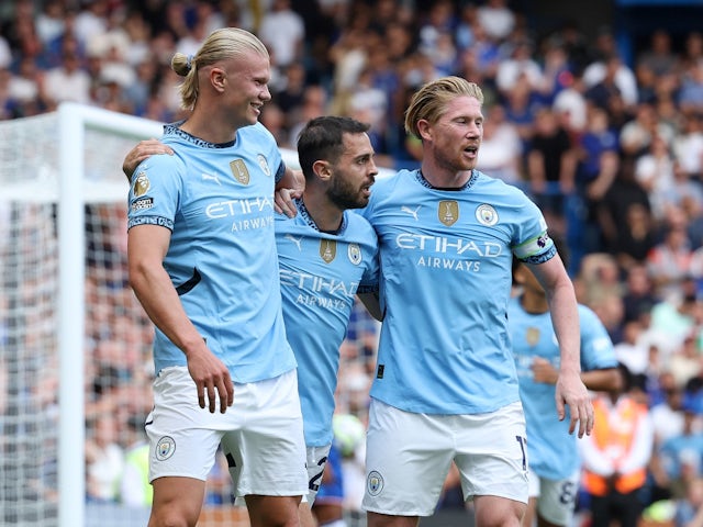 Manchester City's Erling Haaland celebrates with Kevin De Bruyne and Bernardo Silva after scoring their first goal on August 18, 2024