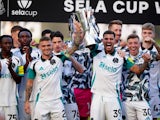 Newcastle United's Kieran Trippier and Bruno Guimaraes lift the Sela Cup after a pre-season friendly match on August 10, 2024