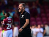 Jon Brady, Manager of Northampton Town celebrates on August 17, 2024