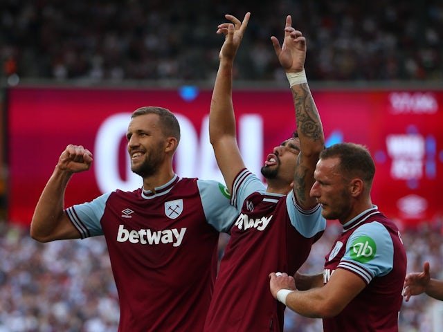 West Ham United's Lucas Paqueta celebrates scoring their first goal with Tomas Soucek and Vladimir Coufal on August 17, 2024