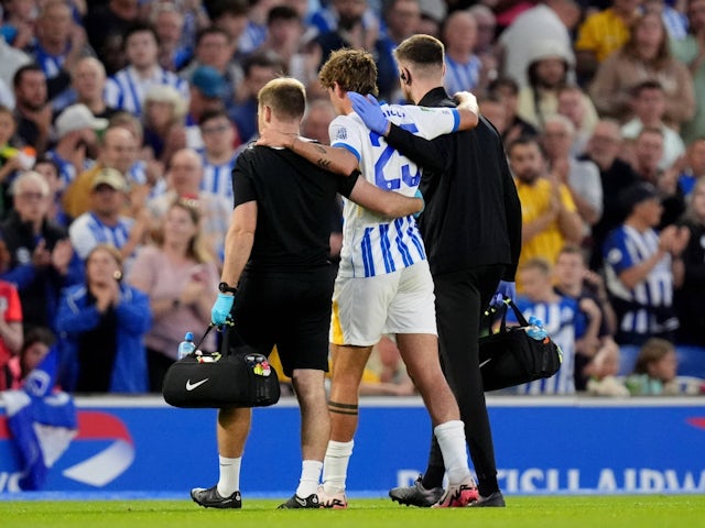 Brighton & Hove Albion's Matt O'Riley is helped off the pitch after sustaining an injury on August 27, 2024