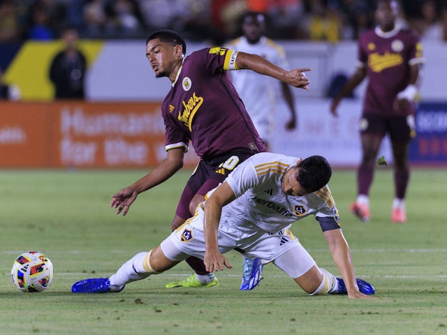 Evander of the Portland Timbers and Maya Yoshida 4 of the LA Galaxy battle for possession on August 28, 2024