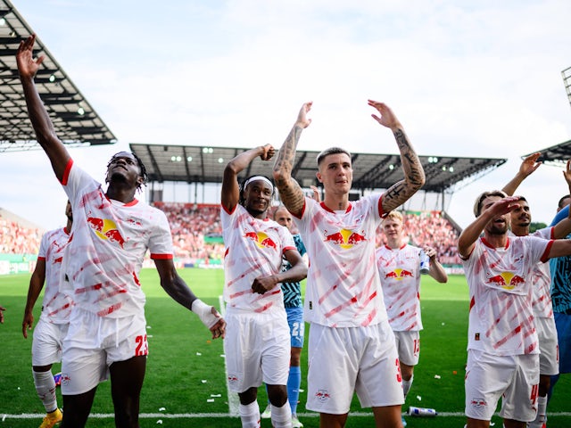 Leipzig's Castello Junior Lukeba, Mohamed Simakan and Benjamin Sesko celebrate victory in the DFB Cup on August 20, 2024