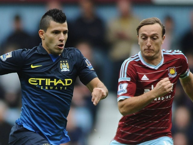 Manchester City's Sergio Aguero in action with West Ham United's Mark Noble on October 25, 2014