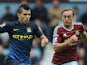 Manchester City's Sergio Aguero in action with West Ham United's Mark Noble on October 25, 2014