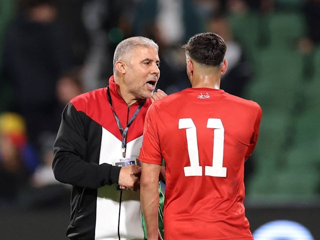 Palestine boss Makram Daboub talks with Oday Dabbagh after their side's match against Australia on June 11, 2024