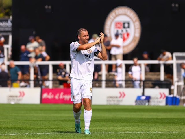 Michael Cheek of Bromley applauds the crowd after AFC Wimbledon game on August 17, 2024