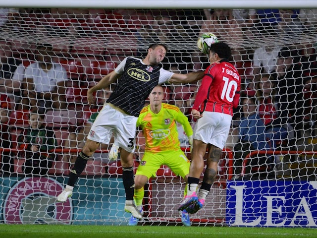 Ben Purrington of Exeter City in action with Josh Gordon of Walsall on August 13, 2024