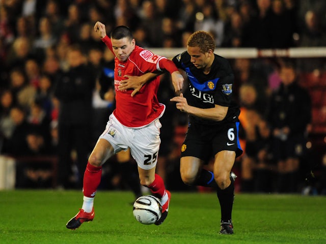 Manchester United's Wes Brown and Barnsley's Adam Hammill battle on October 27, 2009