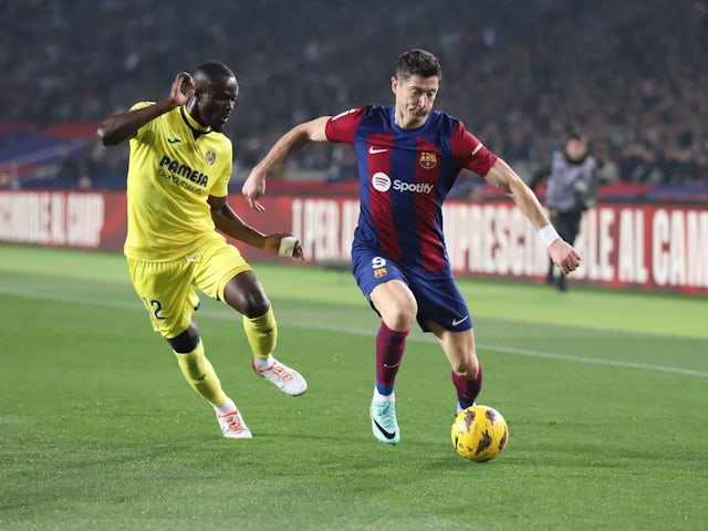 Barcelona's Robert Lewandowski in action with Villarreal's Eric Bailly on January 27, 2024