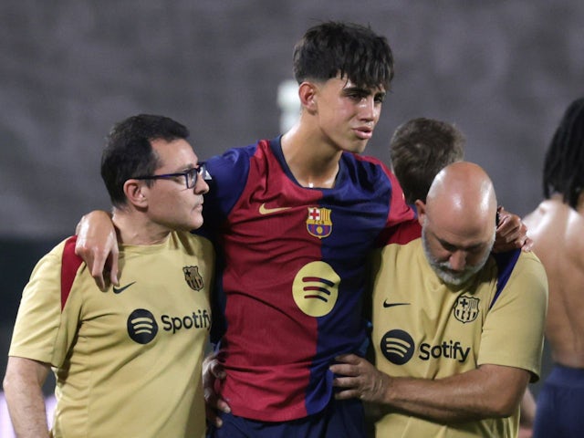 Barcelona's Marc Bernal leaves the field helped by the doctors after being injured on August 27, 2024