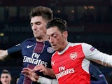 Arsenal's Mesut Ozil and Paris Saint-Germain's (PSG) Thomas Meunier pictured in November 2016