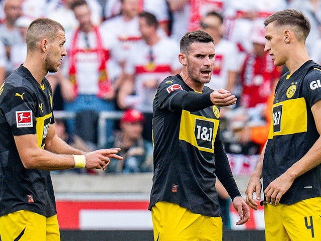 Waldemar Anton, Pascal Gross, Nico Schlotterbeck of Borussia Dortmund argue during their side's match against Stuttgart on September 22, 2024