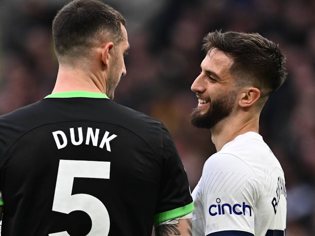 Lewis Dunk of Brighton & Hove Albion and Rodrigo Bentancur of Tottenham Hotspur during the Premier League match on February 10, 2024