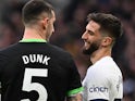 Lewis Dunk of Brighton & Hove Albion and Rodrigo Bentancur of Tottenham Hotspur during the Premier League match on February 10, 2024