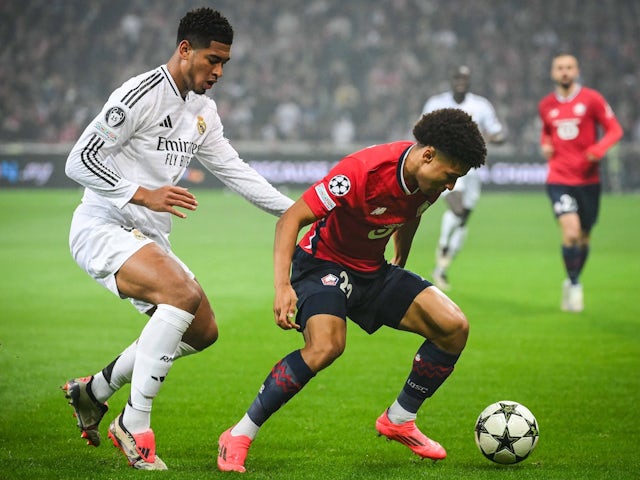 Real Madrid's Jude Bellingham in action with Lille's Tiago Santos on October 2, 2024