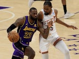 LeBron James of the Los Angeles Lakers dribbles the ball against the Phoenix Suns' Kevin Durant on January 11, 2024