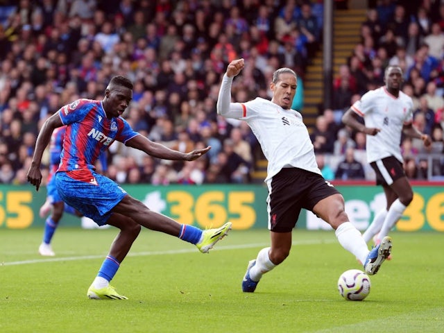 Crystal Palace's Ismaila Sarr shoots whilst under pressure from Liverpool's Virgil van Dijk during their side's Premier League match, on October 5, 2024