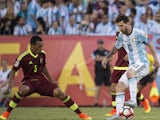 Argentina's Lionel Messi and Venezuela's Arquimedes Figuera in action on June 19, 2016