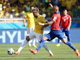 Brazil's Neymar and Chile's Arturo Vidal in action on June 28, 2014