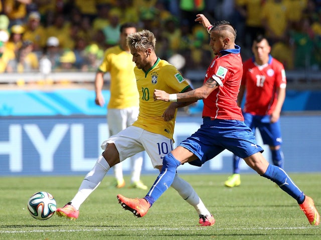 Brazil's Neymar and Chile's Arturo Vidal in action on June 28, 2014