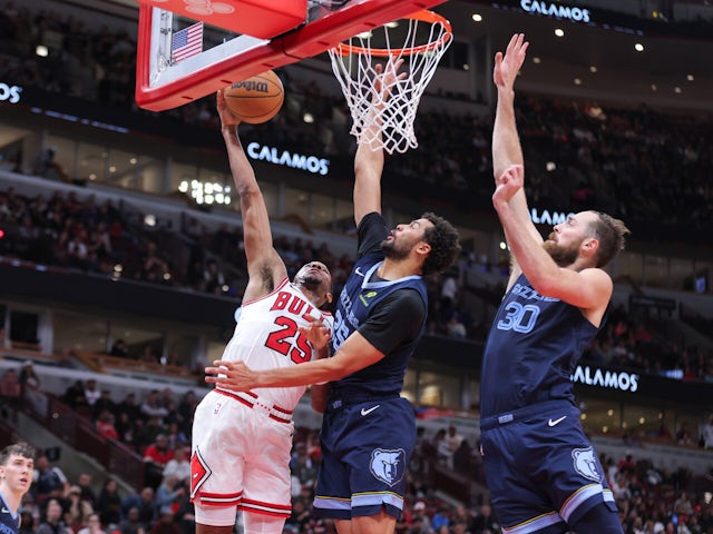  Chicago Bulls forward Dalen Terry shoots the ball over over Memphis Grizzlies' Maozinha Pereira and Jay Huffon October 13, 2024