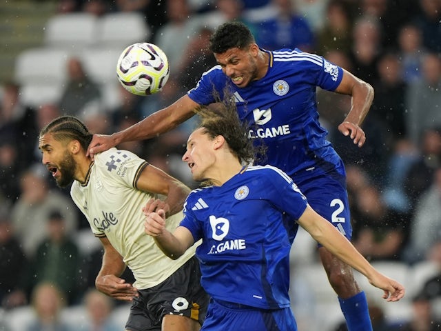 Everton striker Dominic Calvert-Lewin battles with Leicester City's Wout Faes and James Justin on September 21, 2024