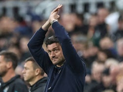 Manager of AFC Wimbledon Johnnie Jackson applauds fans during his side's Carabao Cup game against Newcastle United, on October 1, 2024