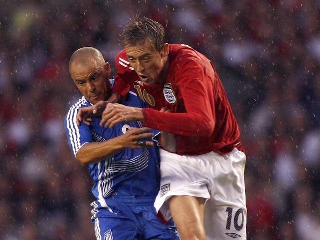 England's Peter Crouch in action with Greece's Stylianos Giannakopoulos on August 16, 2006