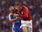 England's Peter Crouch in action with Greece's Stylianos Giannakopoulos on August 16, 2006