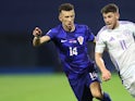 Ryan Christie of Scotland runs with the ball whilst under pressure from Ivan Perisic of Croatia during their side's UEFA Nations League match, on October 12, 2024