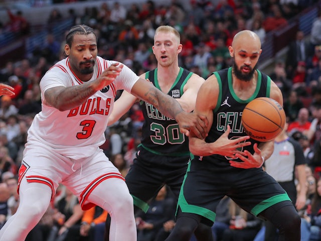 Derrick White 9 of the Boston Celtics battle for a loose ball on October 5, 2024