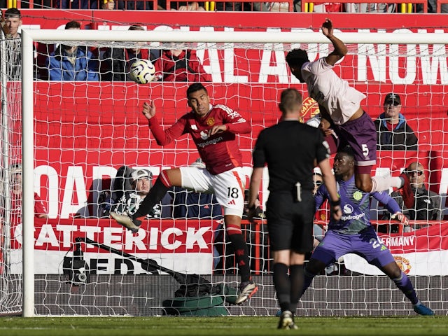 Brentford's Ethan Pinnock scores past Manchester United's Casemiro and Andre Onana on October 19, 2024