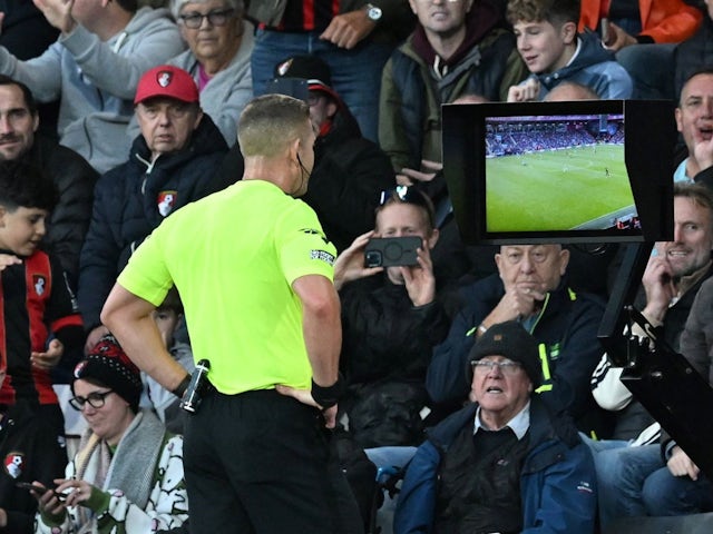 Referee Robert Jones checks VAR and then sends off William Saliba of Arsenal during the Premier League match between Bournemouth and Arsenal, on October 19, 2024