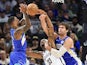 Milwaukee Bucks guard Damian Lillard (L), Brooklyn Nets center Nic Claxton (C) and Milwaukee Bucks center Brook Lopez battle for a rebound on October 18, 2024