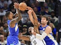 Milwaukee Bucks guard Damian Lillard (L), Brooklyn Nets center Nic Claxton (C) and Milwaukee Bucks center Brook Lopez battle for a rebound on October 18, 2024