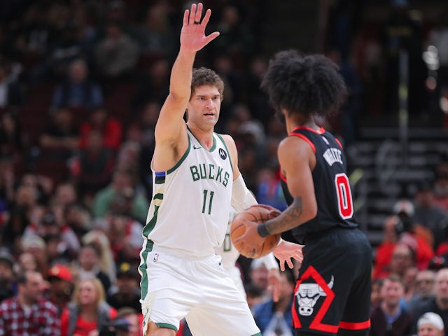 Brook Lopez of the Milwaukee Bucks guards Coby White of the Chicago Bulls on October 23, 2024