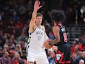 Brook Lopez of the Milwaukee Bucks guards Coby White of the Chicago Bulls on October 23, 2024