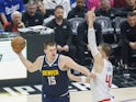 Denver Nuggets Nikola Jokic (L) is defended by Los Angeles Clippers Ivica Zubac on October 18, 2024