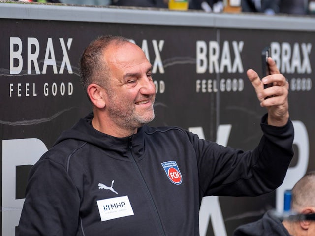 Frank Schmidt of FC Heidenheim takes a selfie for a fan before his side's match against Borussia Monchengladbach, on October 19, 2024