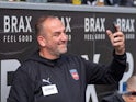 Frank Schmidt of FC Heidenheim takes a selfie for a fan before his side's match against Borussia Monchengladbach, on October 19, 2024