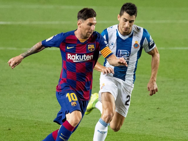 Barcelona's Lionel Messi and Espanyol's Marc Roca on July 9, 2020