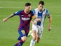 Barcelona's Lionel Messi and Espanyol's Marc Roca on July 9, 2020