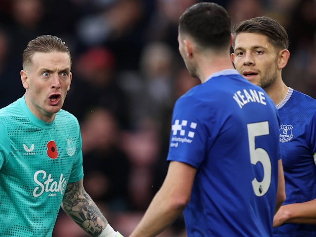 Everton goalkeeper Jordan Pickford speaks to teammates Michael Keane and James Tarkowski on November 2, 2024