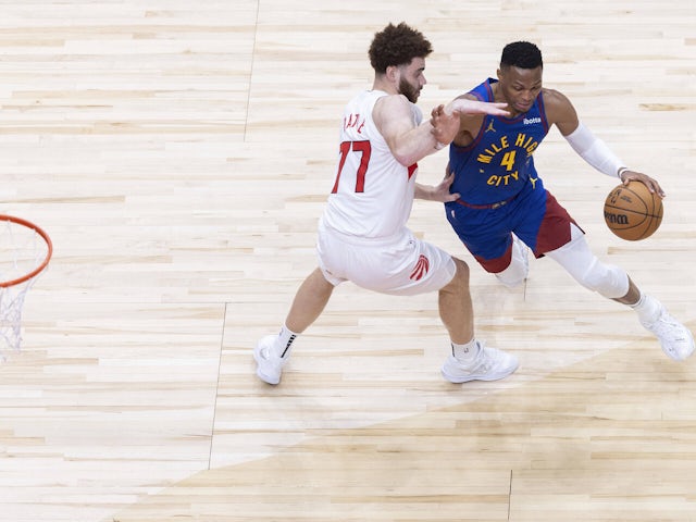 Russell Westbrook (R) of Denver Nuggets dribbles as Jamison Battle of Toronto Raptors defends  on November 5, 2024