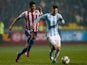 Argentina's Lionel Messi and Paraguay's Victor Caceres on June 30, 2015