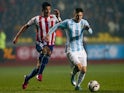 Argentina's Lionel Messi and Paraguay's Victor Caceres on June 30, 2015