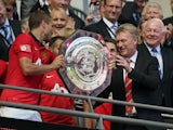 Manchester United manager David Moyes and captain Nemanja Vidic with the Community Shield on August 11, 2013